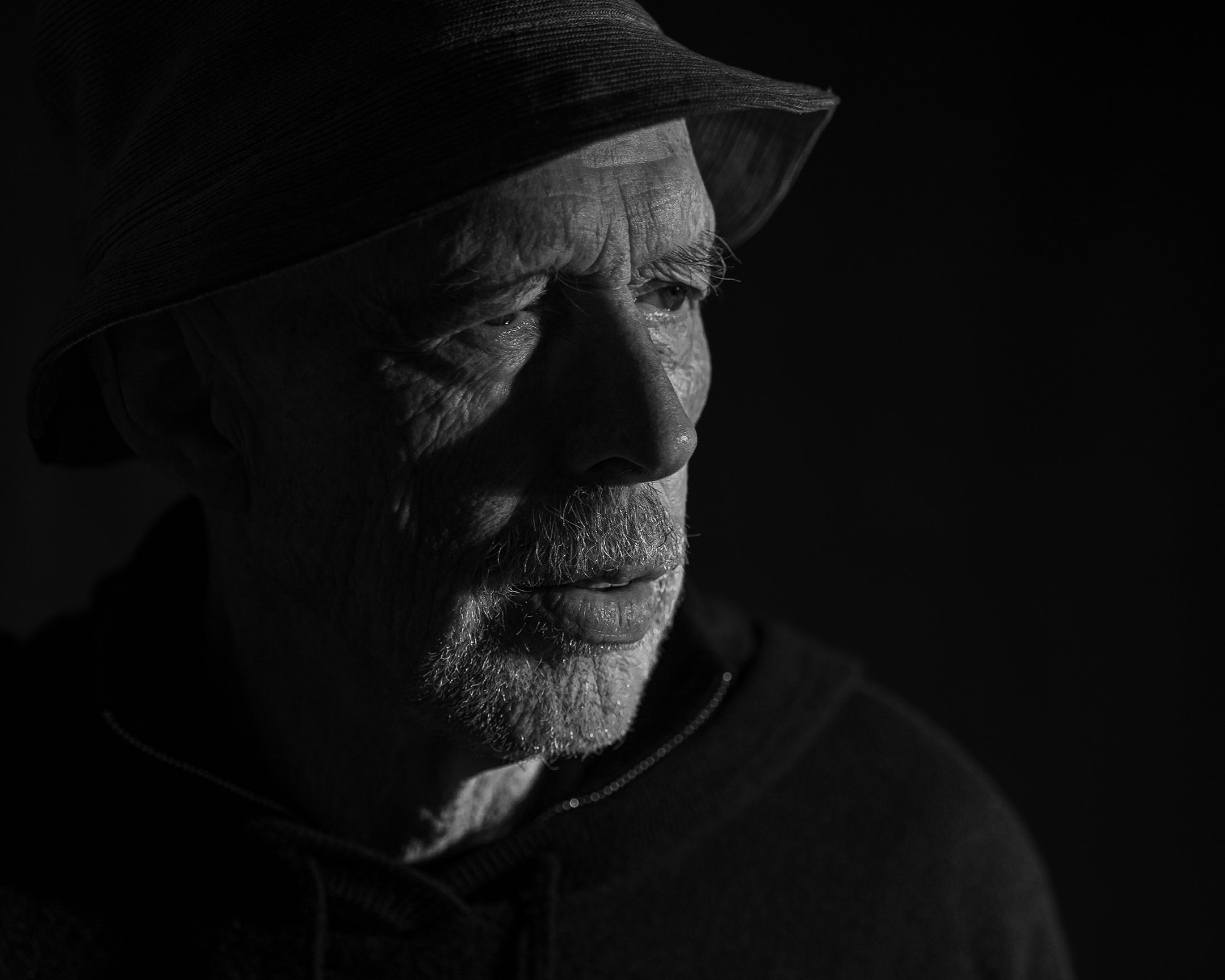 Kevin, photographed as himself, in his own hat — in black and white.